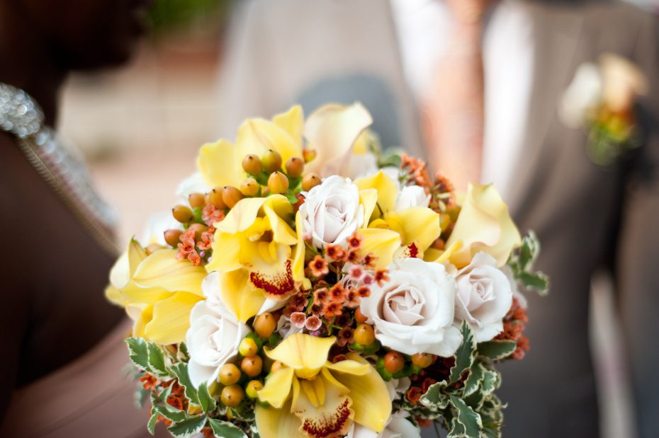Yellow white and orange bride bouquet with berries