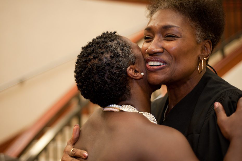 Bride hugging judge at courthouse wedding