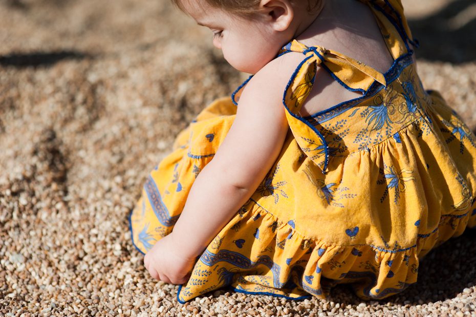 baby playing in sand