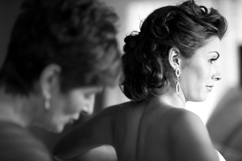mom helping bride get dressed