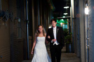 bride and groom arrive at the foundry at puritan mill
