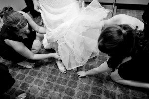 putting on bride's shoes