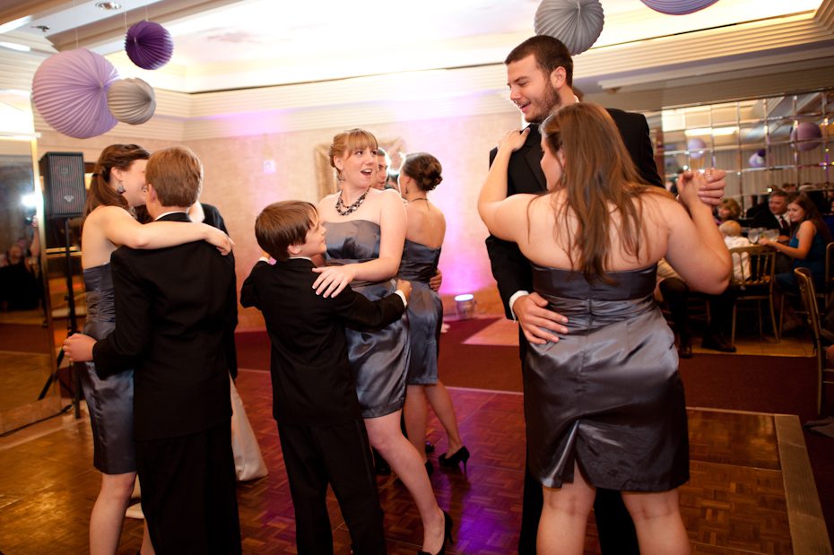 wedding party dances with bride and groom