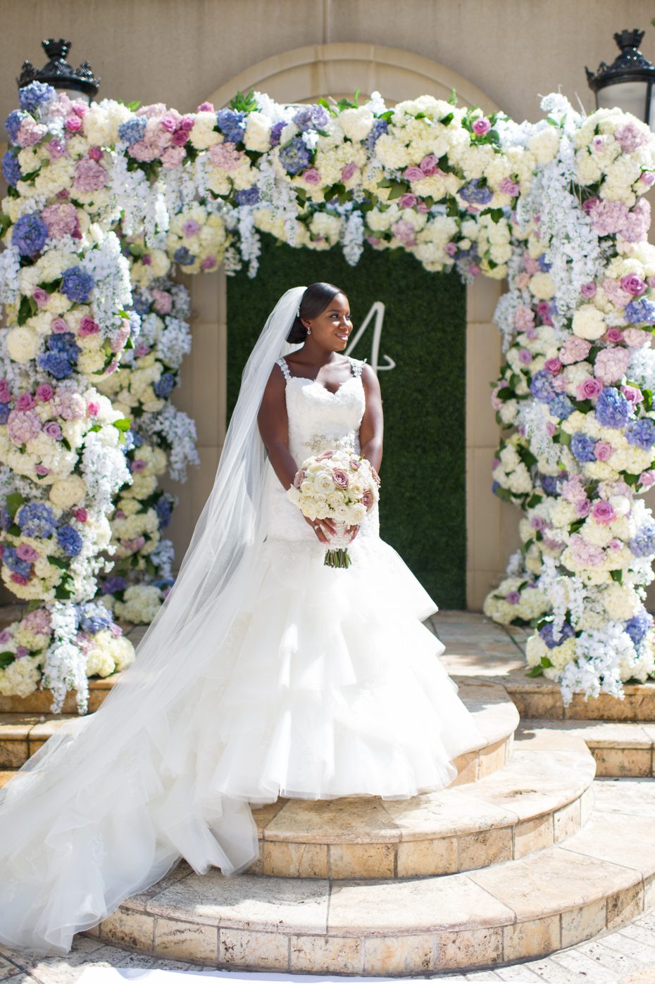 Bride in front of floral arbor by Legendary Events Atlanta