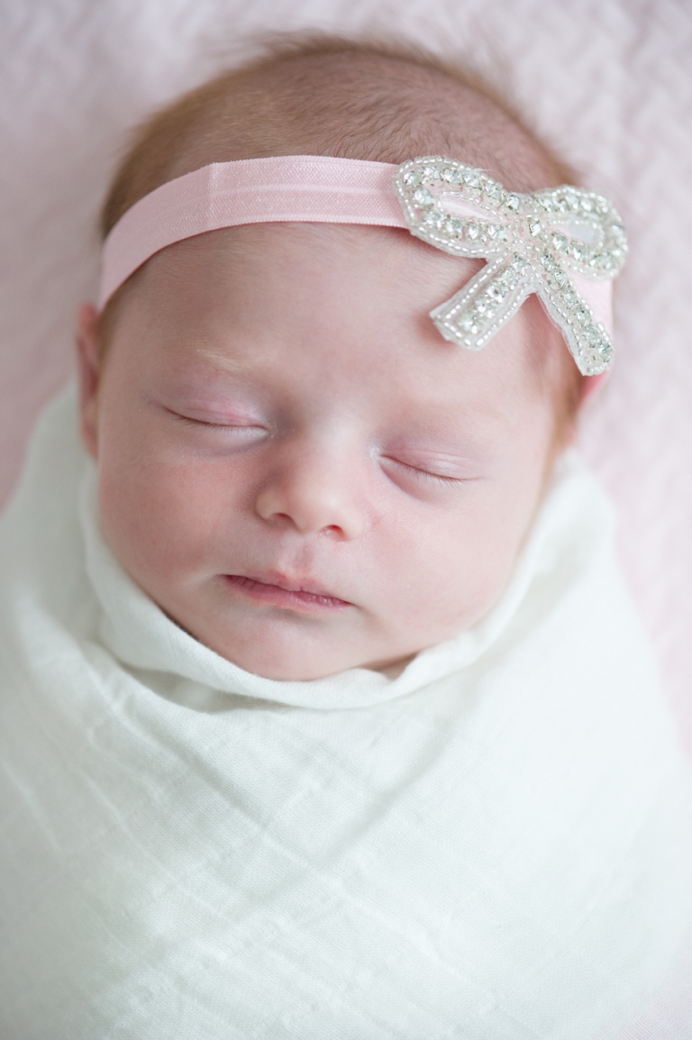 Newborn photo with bow